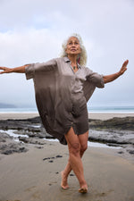 Model wearing the Chico Sheen shirt in certified organic satin-finish cotton, plant-dyed in teal green dip — Sassa Moon New Zealand.