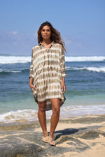 Woman wearing the Tati Shirt Dress made from certified organic cotton, hand-dyed with natural plant pigments in charcoal tie dye, designed in New Zealand and crafted slowly in the hills of Bali. Lightweight, sustainable, and perfect for resortwear and everyday summer styling.